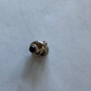 Pandora silver charm bead with a purple accent.